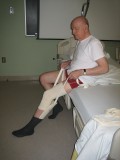  Image of man putting on sock with a sock aid