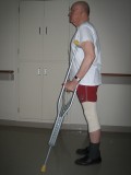 Image of man demonstrating how to use crutches