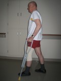 Image of man demonstrating how to use crutches