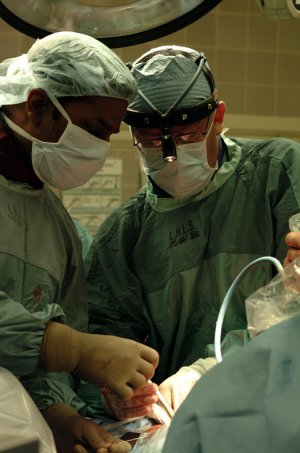 Dr. Kevin Gurr, LHSC Spine Surgeon, pictured at right, performs an artificial disc replacement in the lower spine