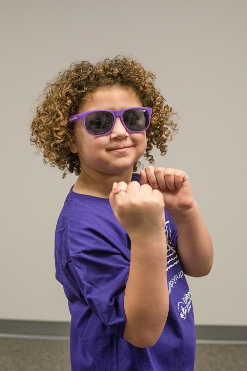 Child in purple sunglasses