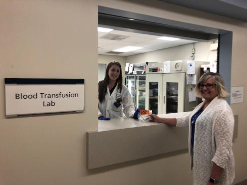 A woman receives a package from the Blood Transfusion Lab