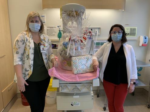 Mother Baby Care Unit staff present a large gift basket for mom and baby generously donated by pharmacist-owners of London and area Shoppers Drug Mart stores.
