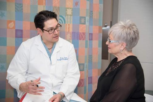 Physician talking to a patient in a hospital room