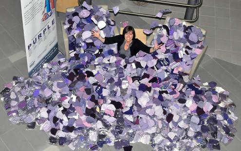 Denise surrounded by hats