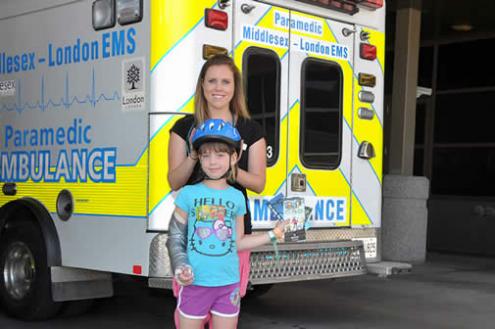 Child with helmet and nurse
