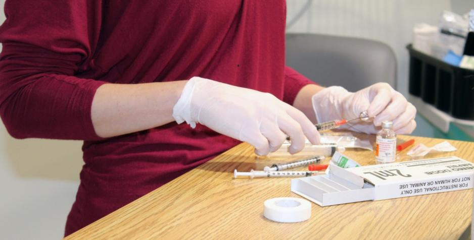 A Nurse loads medication into syringes