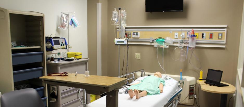 A practice dummy lays unaccompanied in a hospital room