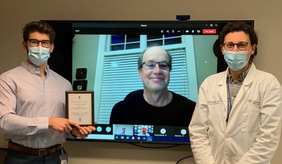 Due to COVID-19, Dr. Qiabi assisted Dr. Inculet as he virtually presents Sebastien Robert with his award