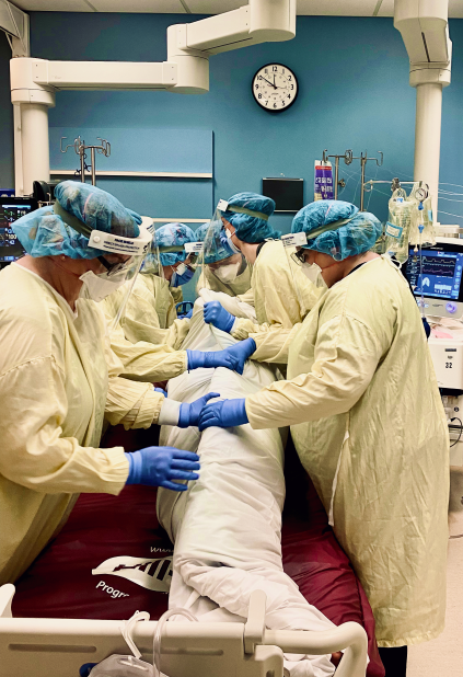 Image: CCTC team members work together to pronate a ventilated COVID-19 patient to assist with breathing.