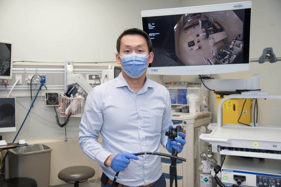 Dr. Michael Sey is holding a colonoscope used for colonoscopies.