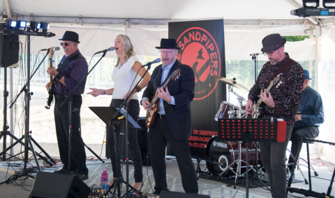 The Sandpipers playing classic rock tunes under the UH 50 celebration tent.