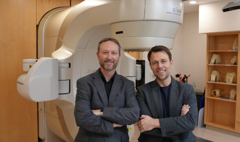 Drs. Gaede and Breadner in front of the linear accelerator
