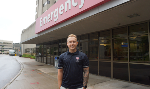 Paramedic Eric Hocking stands in front of the entrance to the Emergency Department at University Hospital