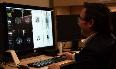 Dr. David Laidley, a nuclear medicine physician at LHSC and a scientist at London Health Sciences Centre Research Institute (LHSCRI), reviewing a scan of a clinical trial participant who has neuroendocrine tumours. 