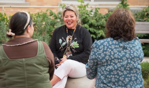 Chantel Antone, LHSC's Indigenous Health Lead sits and chats with two members of the Indigenous Health team.