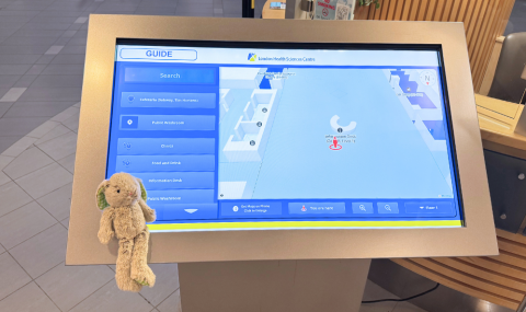 Dr. Hops at a wayfinding kiosk displaying MazeMap