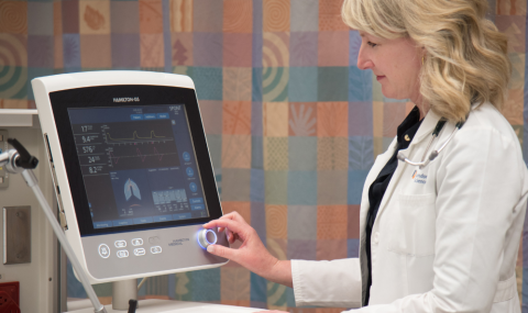 Dr. Karen Bosma selecting a mode on a ventilation machine.