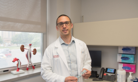 Dr. Landau is pictured with a sample of the aortic stent graft platform
