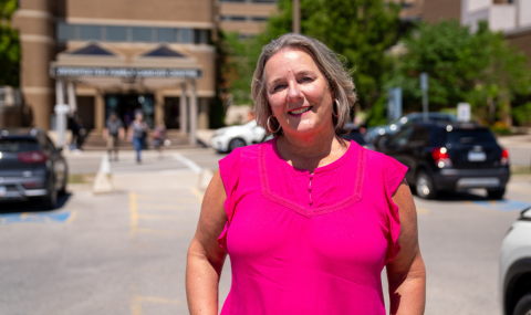 Krystyna Locke standing in Verspeeten Family Cancer Centre parking lot at London Health Sciences Centre.