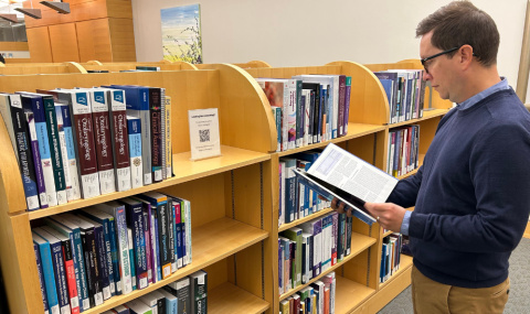 Gabriel Boldt, Clinical Librarian, reviewing information in the Clinical Research Library at London Health Sciences Centre (LHSC)