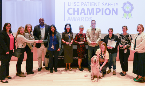 Award recipients stand facing camera smiling