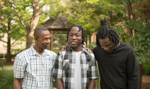From left: Deron Halstead (Jahmari’s father), Jahmari Halstead and Jahvaughn Halstead (Jahmari’s brother) in the cancer garden at Victoria Hospital