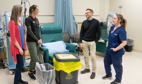 Photo from left: Melissa Costella (Manager, Renal Program), Laura Tait (Charge Nurse, Westmount Dialysis Unit), John Vecchio (Environmental Waste Specialist, Facilities Planning & Design), and Kayla Delaney, Housekeeper (Compass One) discussing the new hemodialysis waste process. 