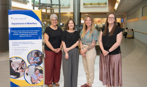 Group of 4 midwives standing in atrium of Victoria Hospital