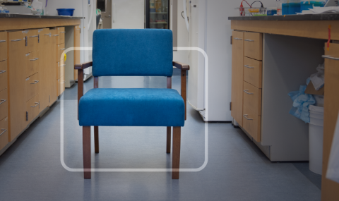 A blue chair stands in the middle of a lab.