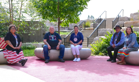 A group of individuals sitting on large rocks in a garden