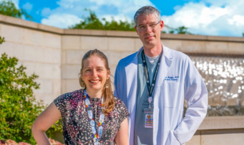 Doctors Rachel Kyle and Brad Moffat are pictured outside of Parkwood Institute in front of a water feature on a sunny day