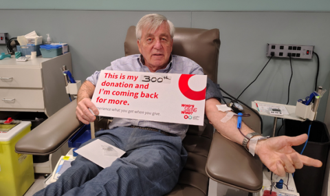 Glen Dietz, Laboratory Quality Consultant at LHSC, sits proudly completing his 300th donation with Canadian Blood Services. He holds a sign that says, “This is my 300th donation and I’m coming back for more.”