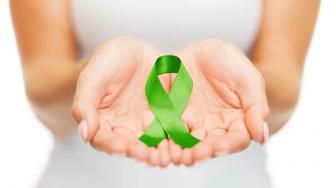 hands holding green ribbon