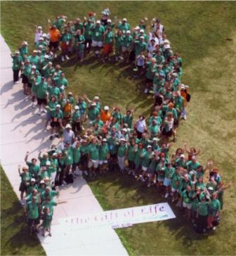 participants forming a green ribbon to show support