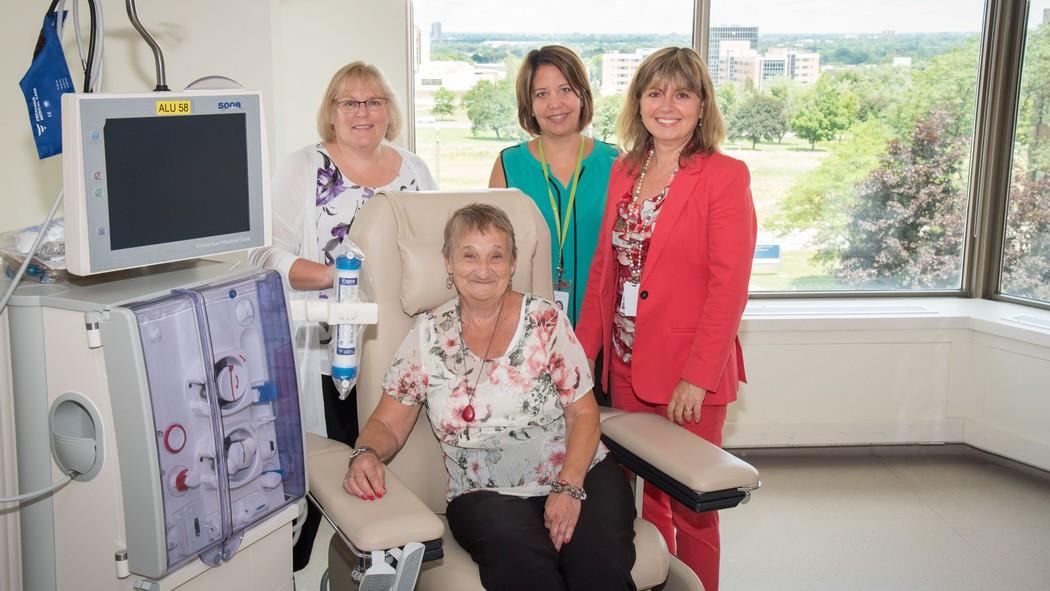 Patient and family advisor, Betty Clinton, sitting in a dialysis chair at Parkwood, worked with (from left) Lori Harwood, April Mullen and Julie Gilvsey (Parkwood). Thumbnail