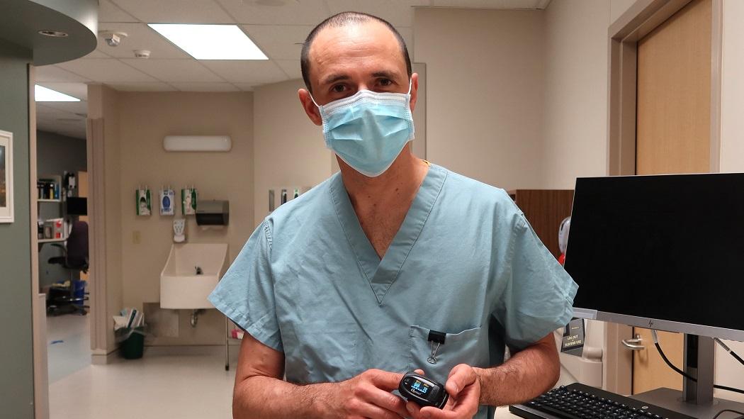 Dr. Marko Mrkobrada, one of the physicians who helped create the Urgent COVID-19 Care Clinic at LHSC shows an example of an oximeter that is sent to high risk patients to help them self-monitor their oxygen levels.