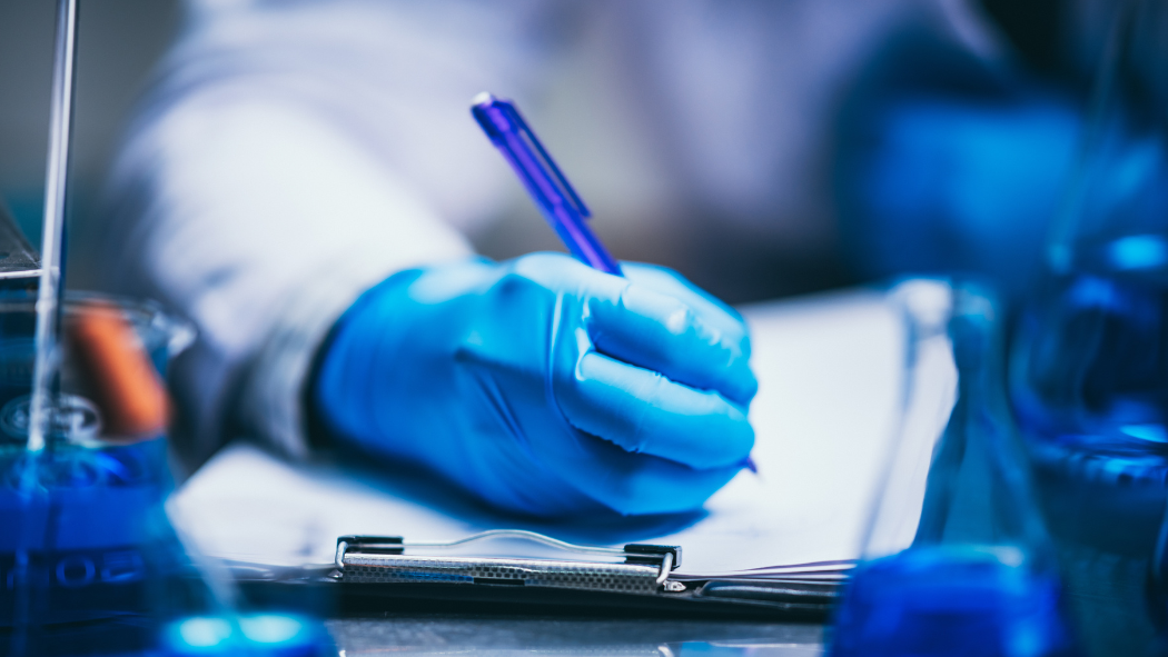 Image of health care worker writing on a chart