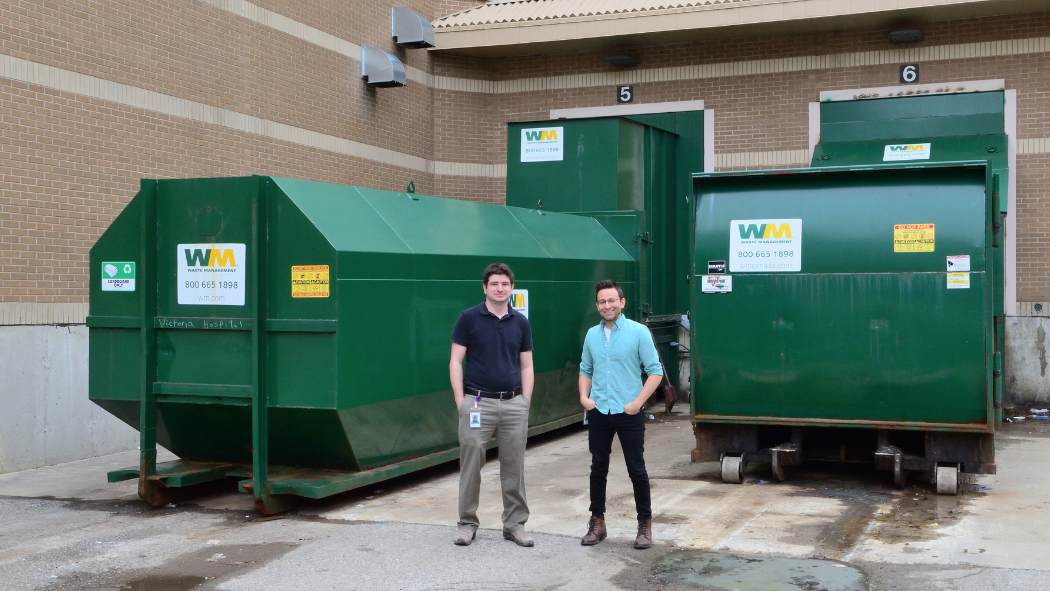 Environmental Stewardship team members outside of the garbage and recycling compactors