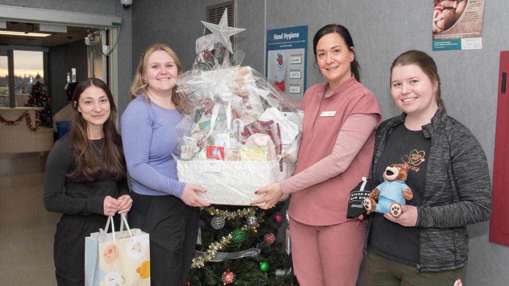 Womens Care staff with New Years baby gift basket