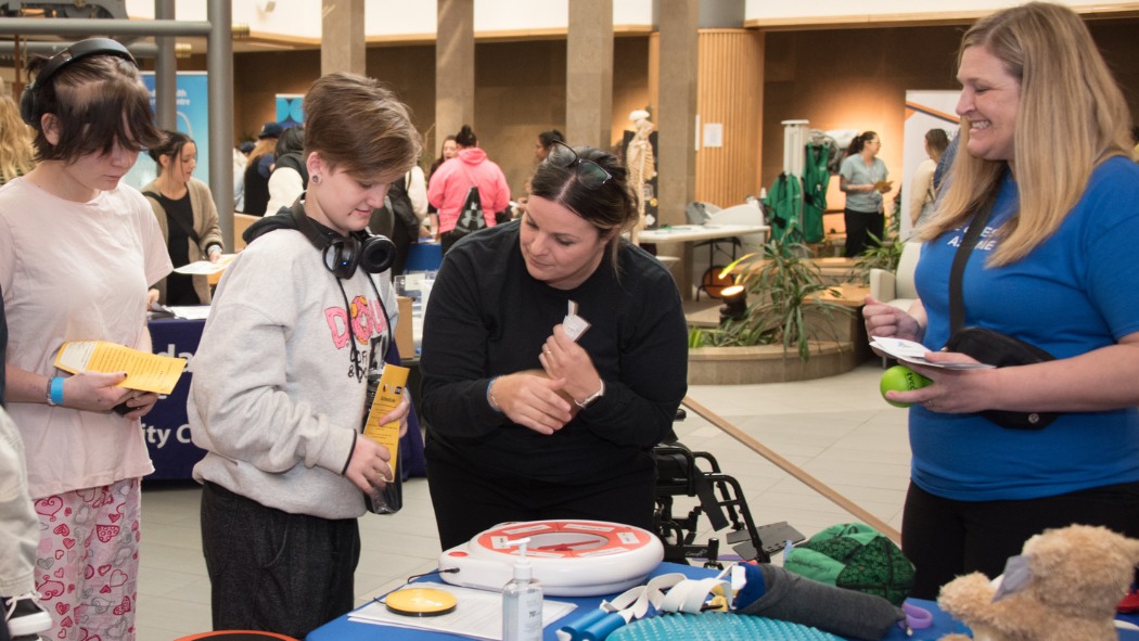 Indigenous students explore the Thames Valley Children's Centre display at the Youth Indigenous Career Fair on February 13, 2024