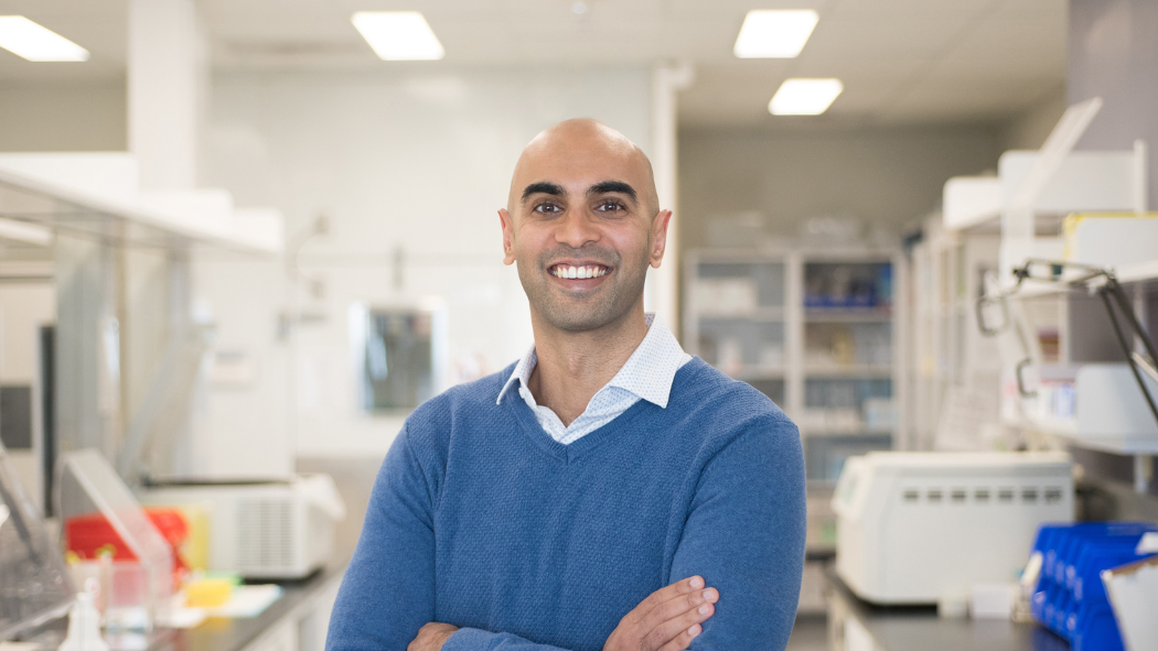 Dr Budhram standing in lab