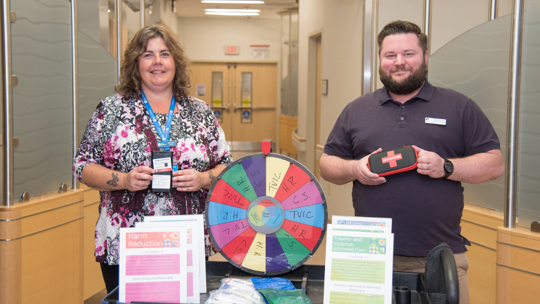 Stephanie McCulligh (left) and Mark Nixon (right) with the roaming education cart they used during the HEED project.
