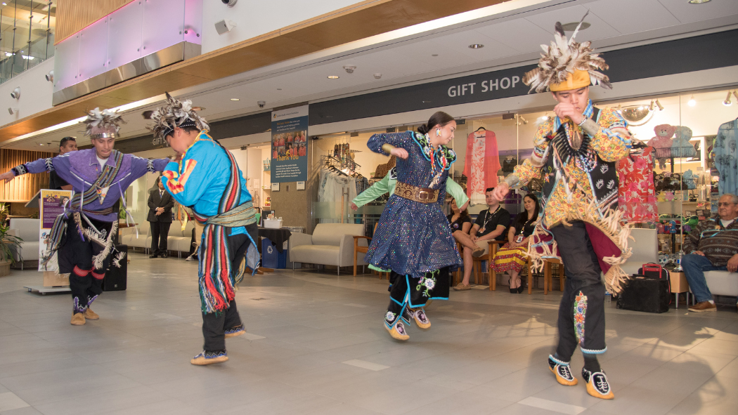 Gavin Summers Sr. drums and sings while smoke dancers, Gavin Summers Jr., Ty Smoke, Roger Antone and Laniya Antone, dance.
