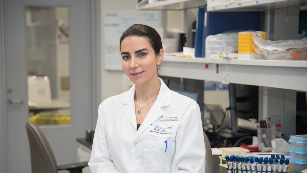 Medical Laboratory Technologist stands in lab