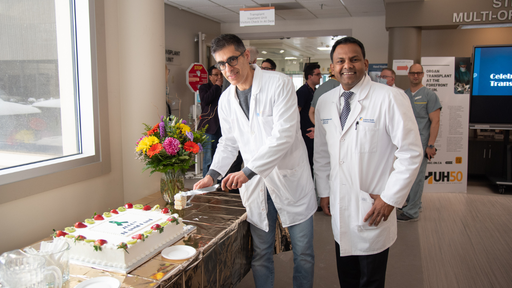 Doctors cutting cake at celebration event