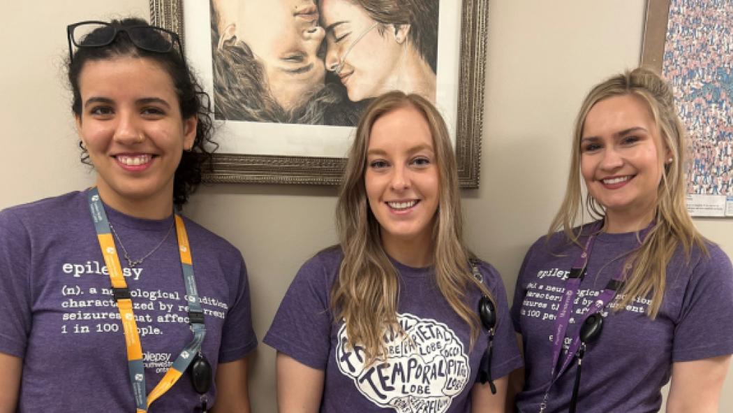Staff pictured wearing purple shirts