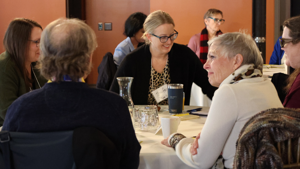 Patient Education Symposium attendees engaging in conversation