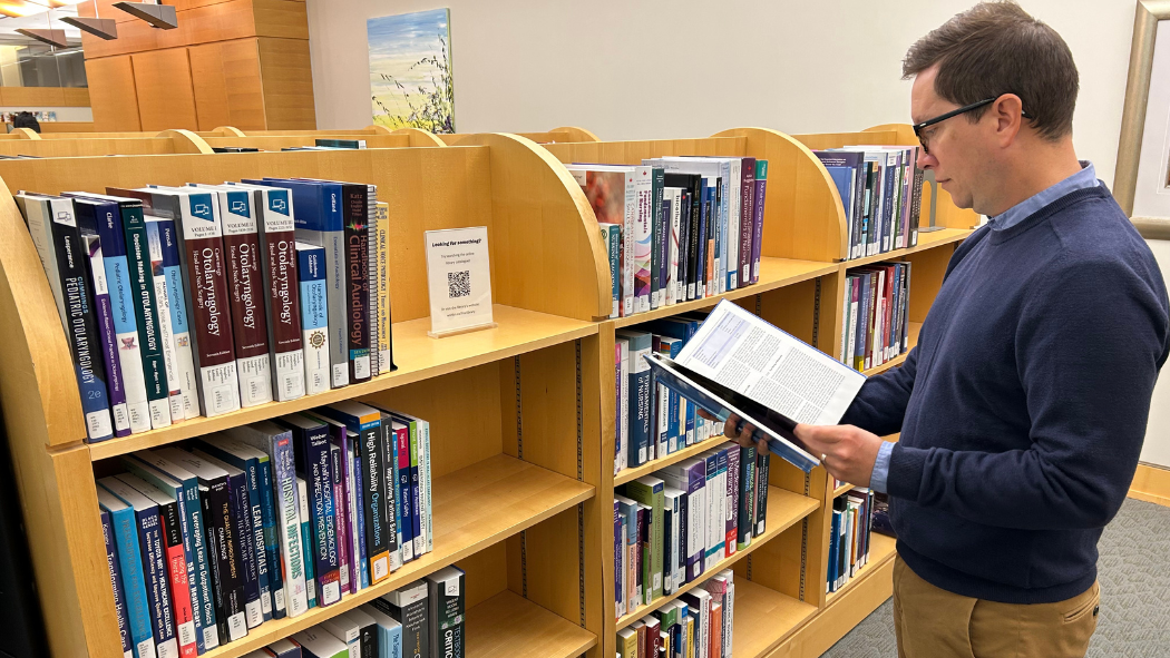 Gabriel Boldt, Clinical Librarian, reviewing information in the Clinical Research Library at London Health Sciences Centre (LHSC)