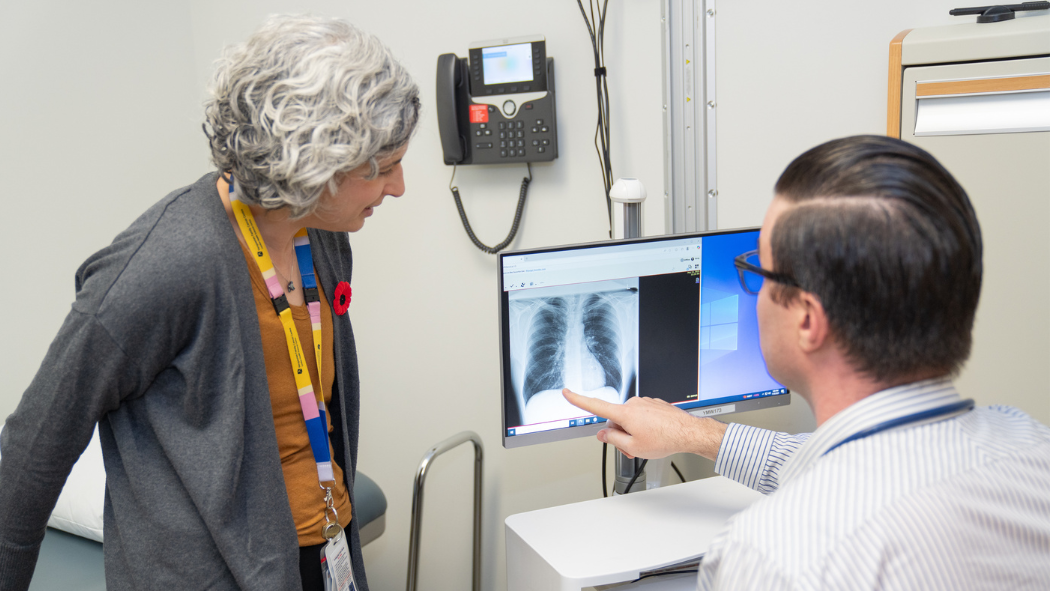 Nurse Practitioners Sari Belzycki and Matthew Parezanovic review a lung X-ray.